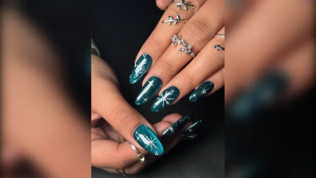 Teal cat eye nails with white snowflakes