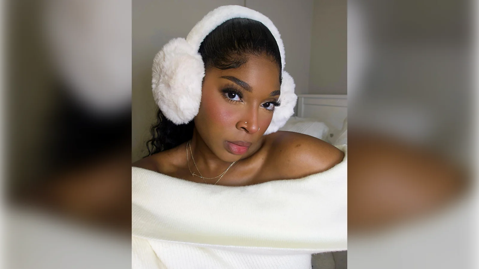 Woman with rosy cold girl blush and white fluffy earmuffs