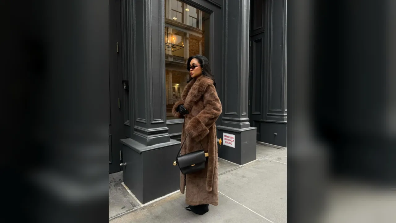 Woman in a long brown faux fur coat on a New York City street