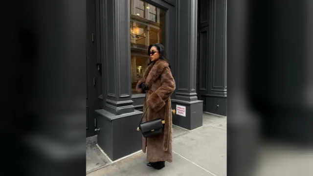 Woman in a long brown faux fur coat on a New York City street