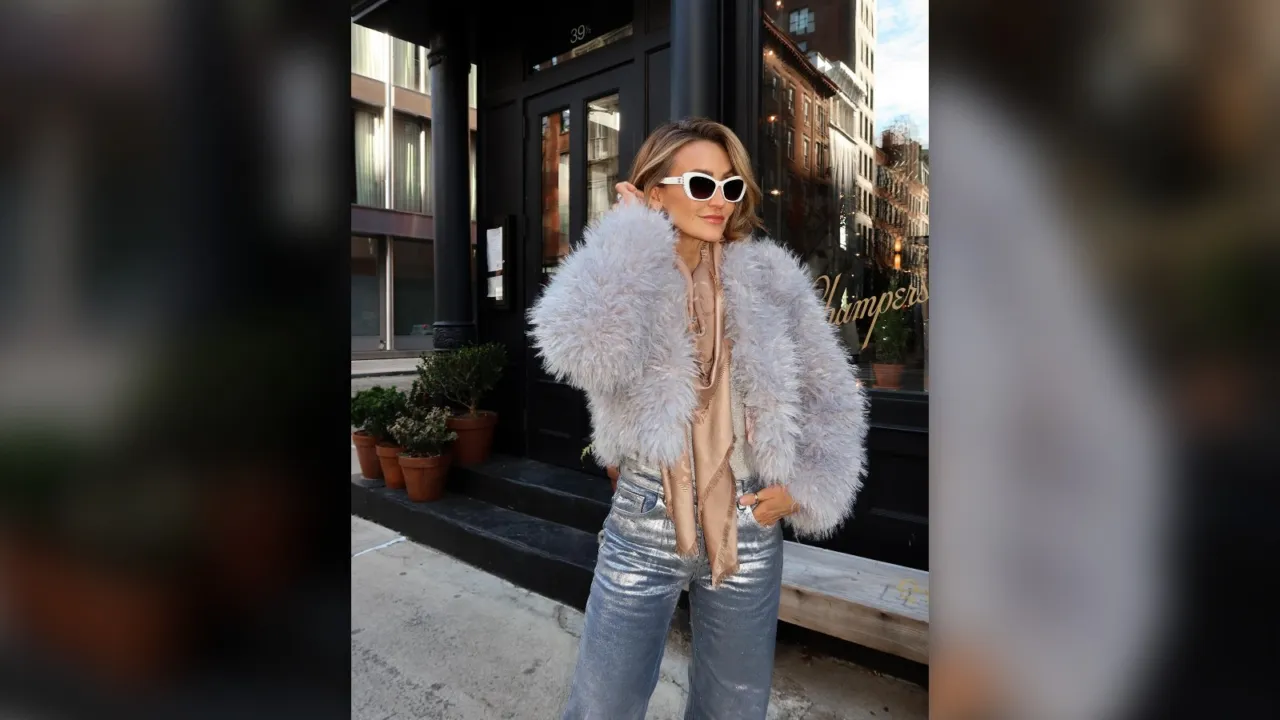 Woman in a fluffy gray coat, sunglasses and sparkly jeans for New Year Eve