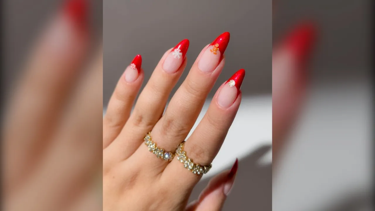Red velvet French almond Christmas nails with tiny gingerbread and snowflake charms