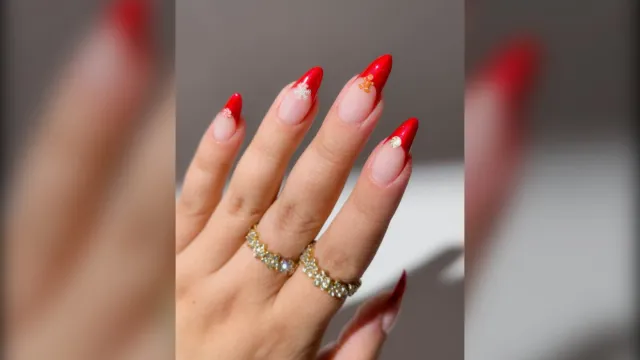Red velvet French almond Christmas nails with tiny gingerbread and snowflake charms