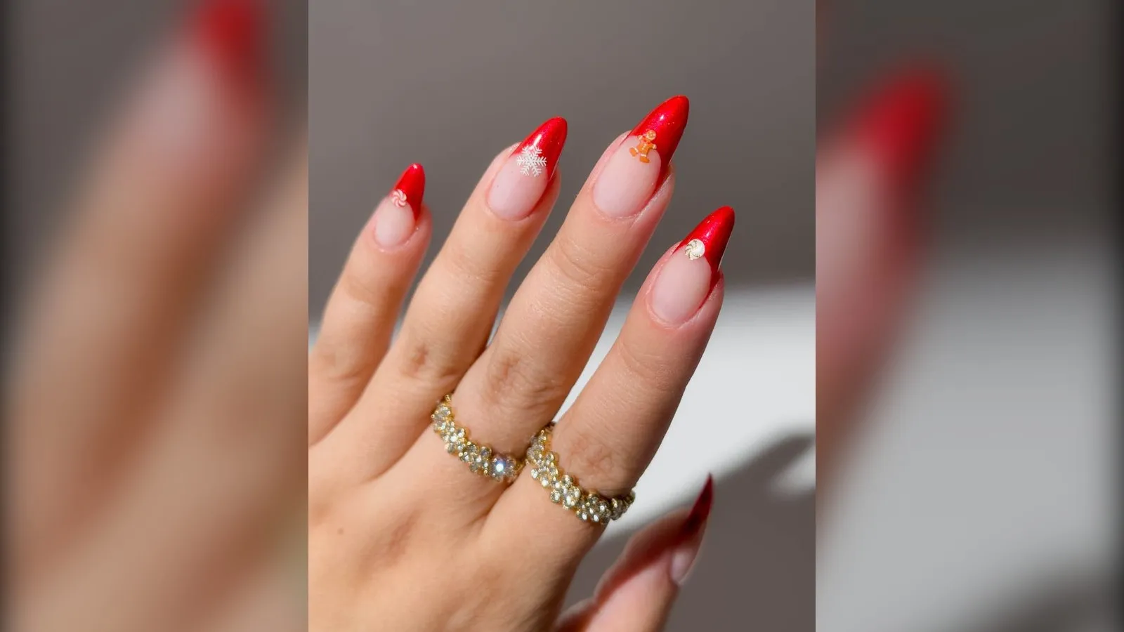 Red velvet French almond Christmas nails with tiny gingerbread and snowflake charms