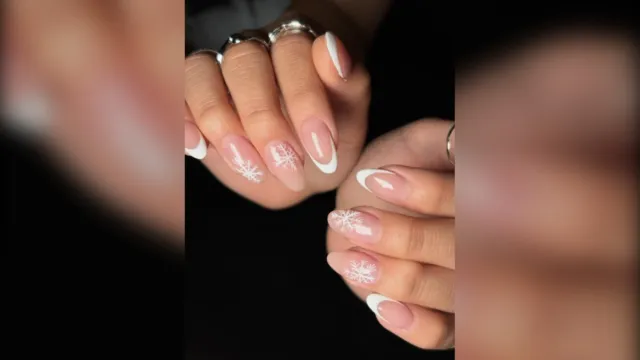 White French almond nails with delicate snowflake art