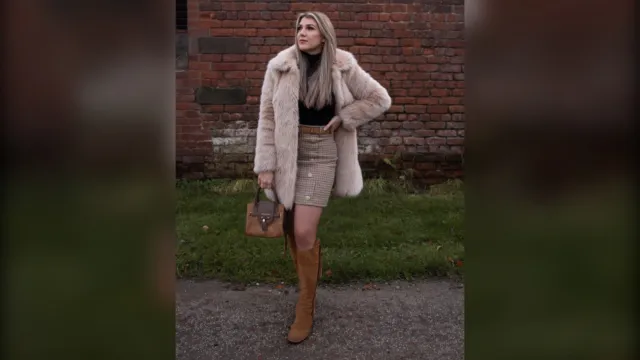 Woman in a pink faux fur coat, check mini skirt and tan knee boots, winter brunch outfit
