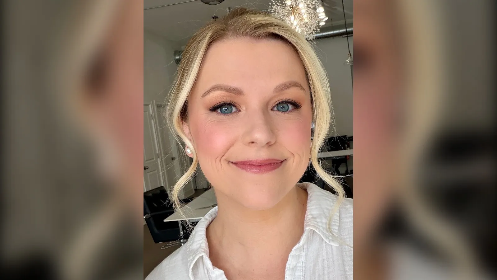Woman with blue eyes wearing apricot eyeshadow and icy pink blush