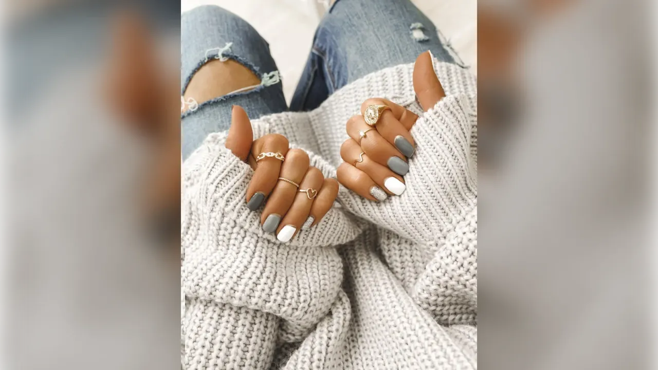 Grey and white winter nails with a chunky white sweater