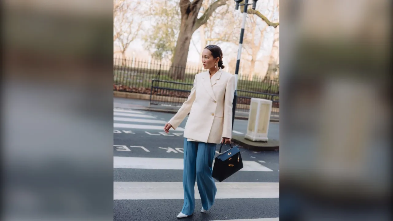 Woman in a cream blazer and wide jeans, a winter work outfit in London