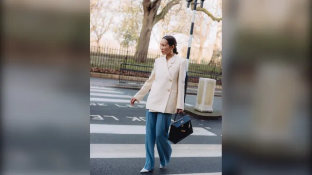 Woman in a cream blazer and wide jeans, a winter work outfit in London